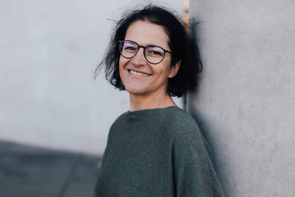 Katja Hainz smiling on wall